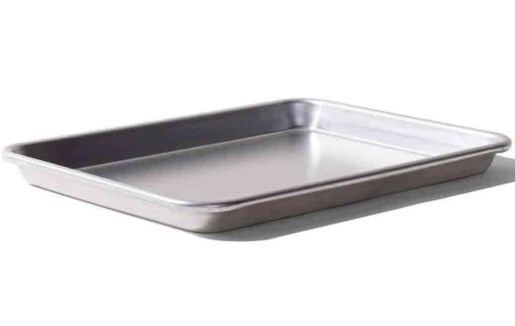 A rectangular metal baking pan with shallow sides, perfect for baking your favorite Chocolate Chip Bars Recipe, shown on a white background.